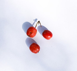 three red berries on white background