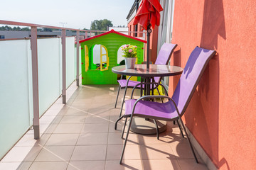 Sunny balcony exterior with chairs