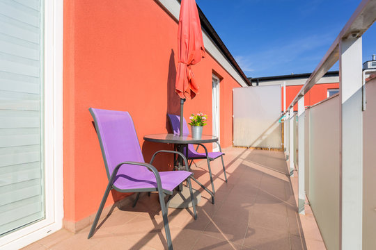 Sunny balcony exterior with chairs