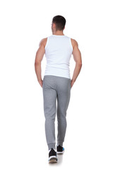 Fototapeta premium rear view of relaxed man walking and looking to side