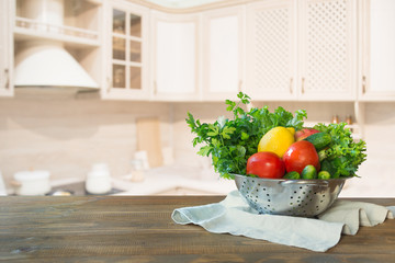 Modern kitchen with fresh vegetables on wooden tabletop, space for you and display products.