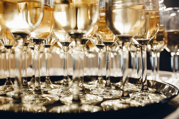 Champagne glasses on gold background. Party and holiday celebration concept.