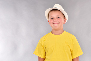 The boy in the hat. A young man in a yellow T-shirt.