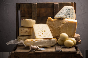Parmesan, taleggio, caciotta and asolo cheese on dark wooden table
