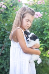 the girl hugs the puppy