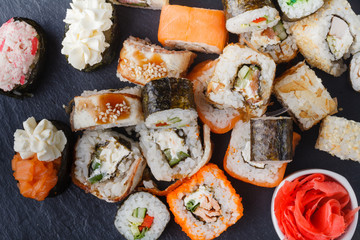 Set of sushi and maki on stone table. Top view with copy space