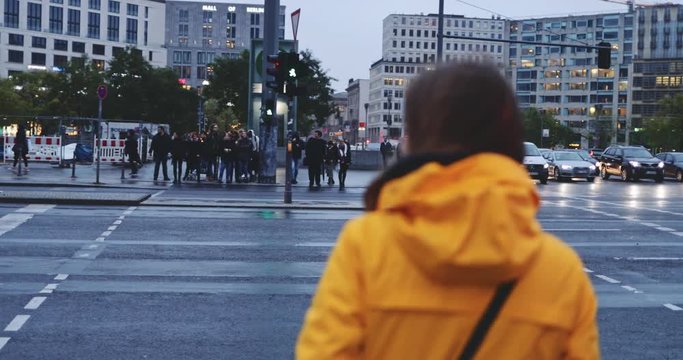 Woman Crossing the Road. SLOW MOTION 4K. Girl crosses the street in the busy city. Night Traffic on background. 