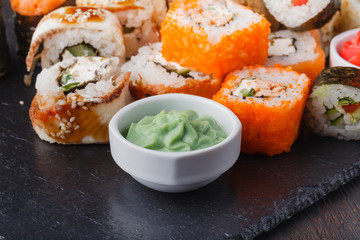 Sushi Roll with salmon, eel, tuna, avocado, cream cheese Philadelphia, caviar tobica, chuka. Sushi menu. Japanese food on table