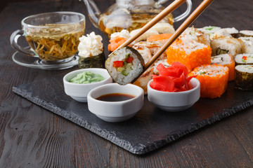 Sushi Roll with salmon, eel, tuna, avocado, cream cheese Philadelphia, caviar tobica, chuka. Sushi menu. Japanese food on table