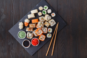 Served sets of sushi rolls with fish, rice,cream cheese and vegetables