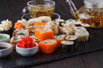 sushi rolls on board ginger wasabi