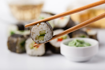 Tasty appetizing multicolored sushi rolls set, served with soy sauce and chopsticks