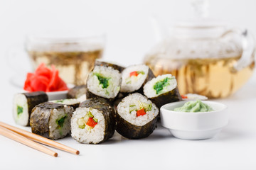 Served sets of sushi rolls with fish, rice,cream cheese and vegetables