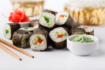 Tasty appetizing multicolored sushi rolls set, served with soy sauce and chopsticks