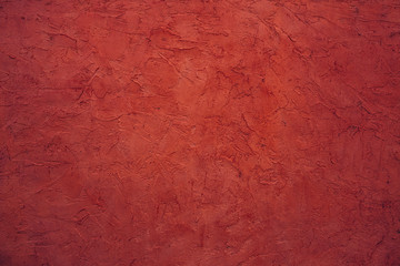 Jester red color plastered wall texture background