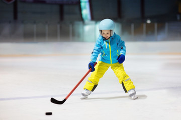Children play ice hockey. Kids winter sport.
