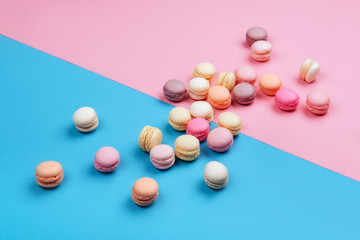 Cake macaron or macaroon on pink and blue background.