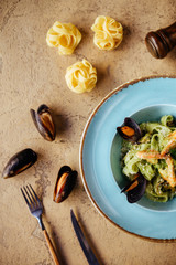 Shellfish Mussels in copper bowl with lemon and herbs. Shellfish seafood.