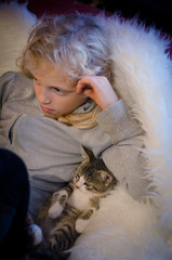 child and cat relaxing on sofa