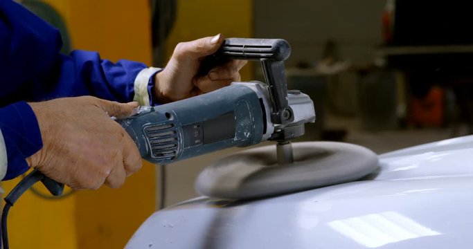 Mechanic polishing a car with grinder 4k