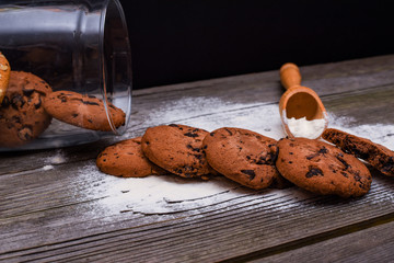 Oatmeal cookies with honey and chocolate cookies on brown wooden table. Food, holiday, cooking, baking background. Concept of home and healthy eating.