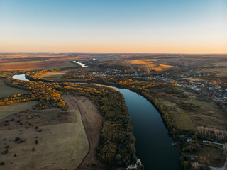 Aerial view of rural countryside, beautiful autumn nature landscape panorama from above with big river and farm fields