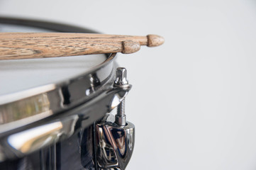 Musical instruments close up. Beautiful snare drum with drummer holding drumsticks 