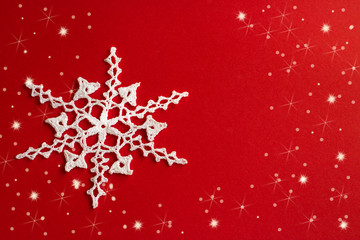 White snowflake on a red background. Christmas and New Year background.