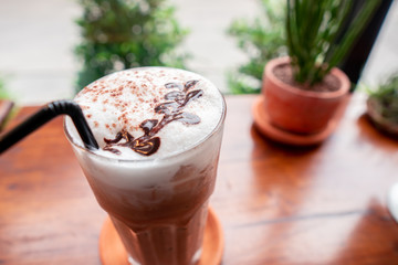 Chocolate paint Milk froth art on cocoa drink in the vintage cafe