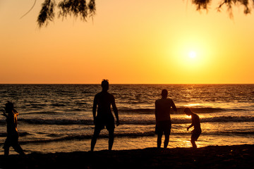 People playing, swimming in the waves in the island of Patmos, Greece in summer time