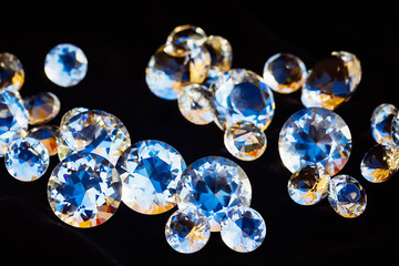 Pile of diamonds on black silk velvet background, retro toned