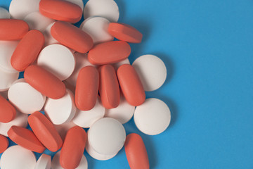 a bunch of pills on an blue background