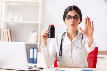 Woman doctor with bottle of medicines