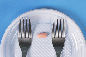 one tablet on a plate with two forks