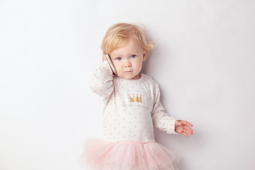 Little blond Girl with Mobile Phone Isolated on White Background. concept a new generation or children and technology