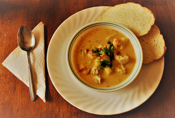 Homemade seafood chowder with bread.