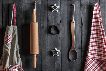 Kitchen utensils hang on a wooden wall