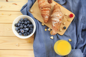 A nutritious healthy breakfast of croissants and fresh juice