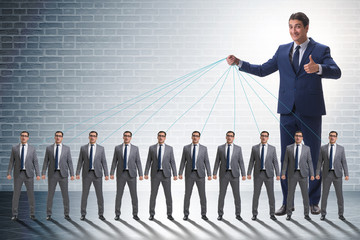 Fototapeta premium Boss employee manipulating his staff in business concept