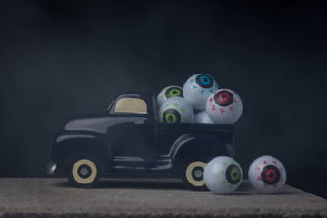 Toy truck with toy eyeballs in the fog