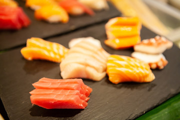 Assortment of tasty and delicious Sashimi or sliced raw fish and seafood. Most popular Japanese food. Low in saturated fat, rich in omega-3 fatty acid and vitamin. Healthy eating and eat well concept.