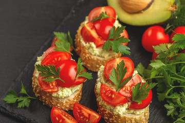 Bruschetta with chopped cherry tomatoes and puree avocado