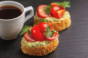 Bruschetta with chopped cherry tomatoes and puree avocado