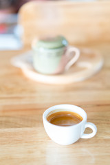 Hot espresso coffee on wood table