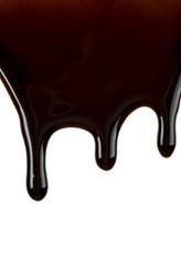 Melted chocolate dripping, white background.