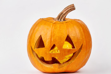 Funny face of Halloween pumpkin. Head of lantern carved from pumpkin, isolated on white background. Funny pumpkin carvings.