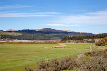 Fototapeta premium A high country farm in New Zealand makes use of the water supply for central pivot irrigators on the farm flats 