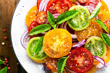 Tomato salad. Fresh vegetable salad with tomatoes, onion and basil