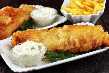 traditional British fish and chips consisting of fried fish, potato chips and mayonnaise