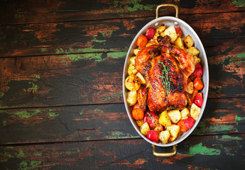 Served roasted Thanksgiving Turkey with vegetables on wooden background